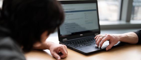 Two students using a laptop together